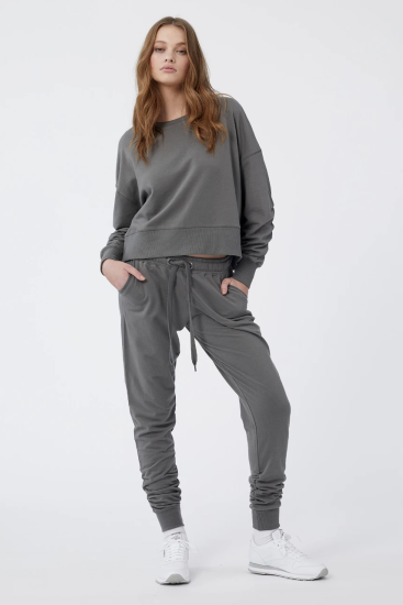 Jac + Mooki Sienna Sweat Pant.  Elasticated waistband, Peached finish, Side pockets, Ribbed cuff, Soft tie and trims, Ruche detail on leg.  Regular fit, Mid Rise  Fabric: 100% GOTS Certified Ultra-Lightweight Organic Cotton French Terry (Global Organic Textile Standard)  Colour: Sedonia Sage  Style: JM8193